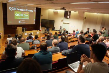 Audience attending a QGIS Feature Frenzy session at the OSGeo Slovenija Conference 2025, Slovenian Forestry Institute